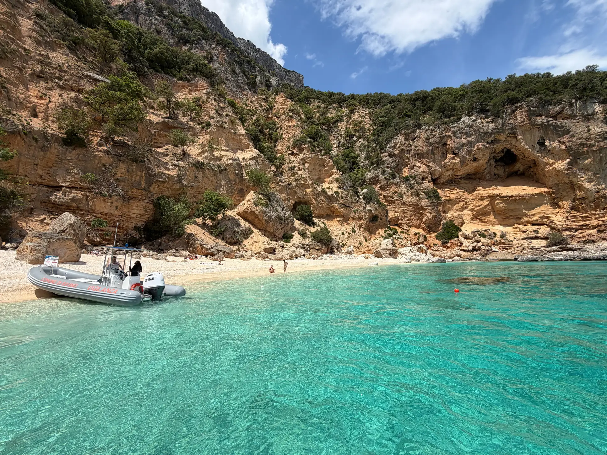 RIB boat at a secluded turquoise cove