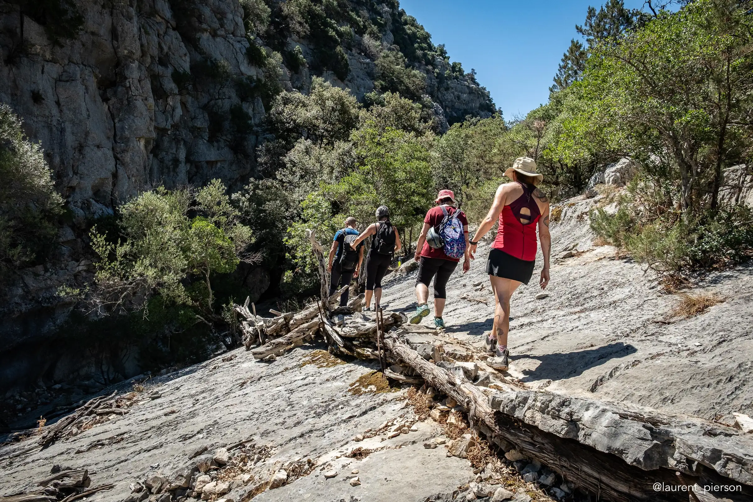 Hikers on rocky terrain in the Supramonte canyon