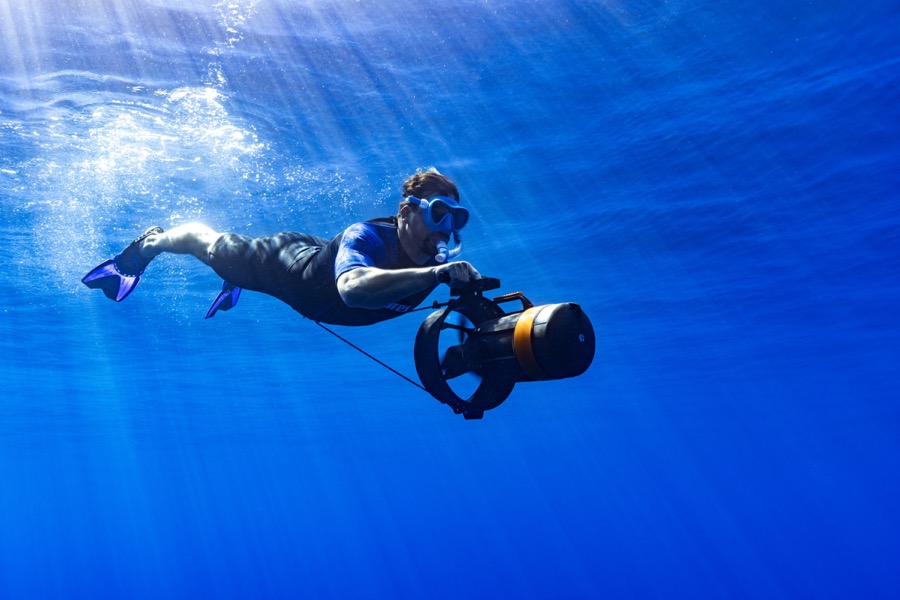 Snorkeler with underwater DPV scooter in the Gulf of Orosei