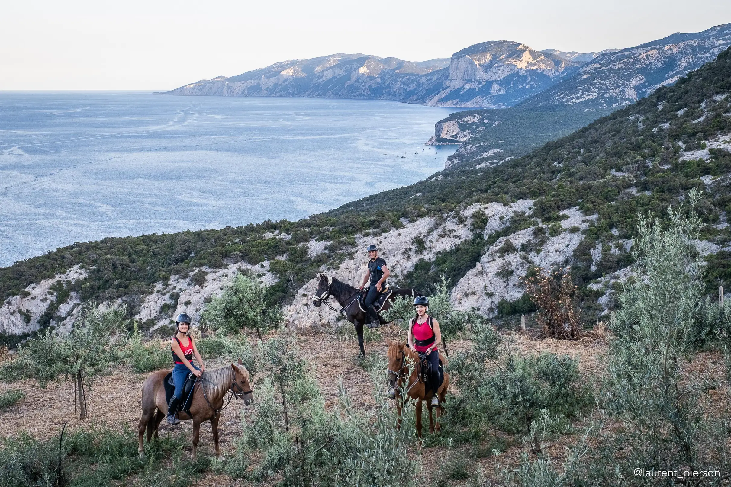 Horse riders with Sardinian coastline panorama