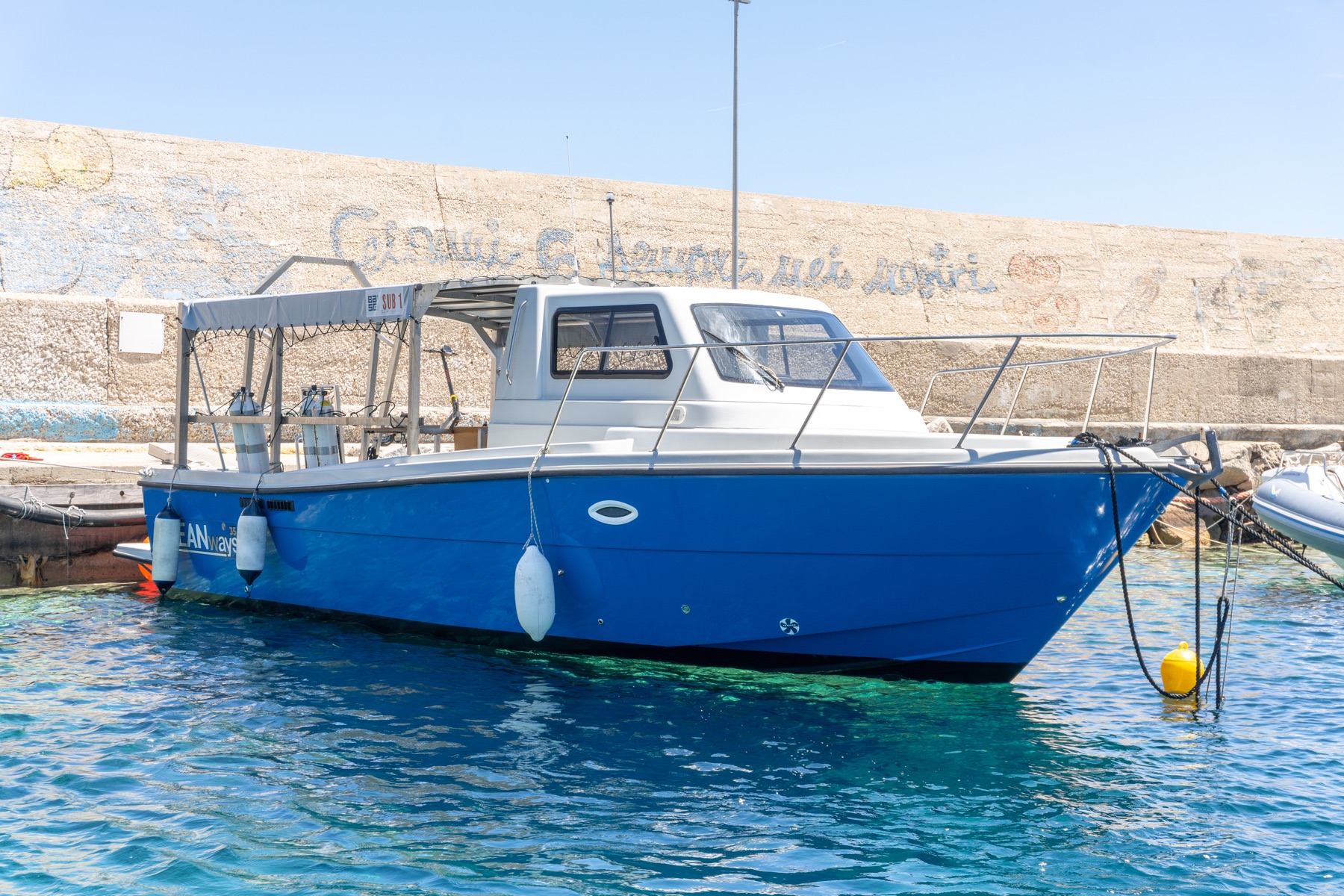 Base One blue dive boat at harbour