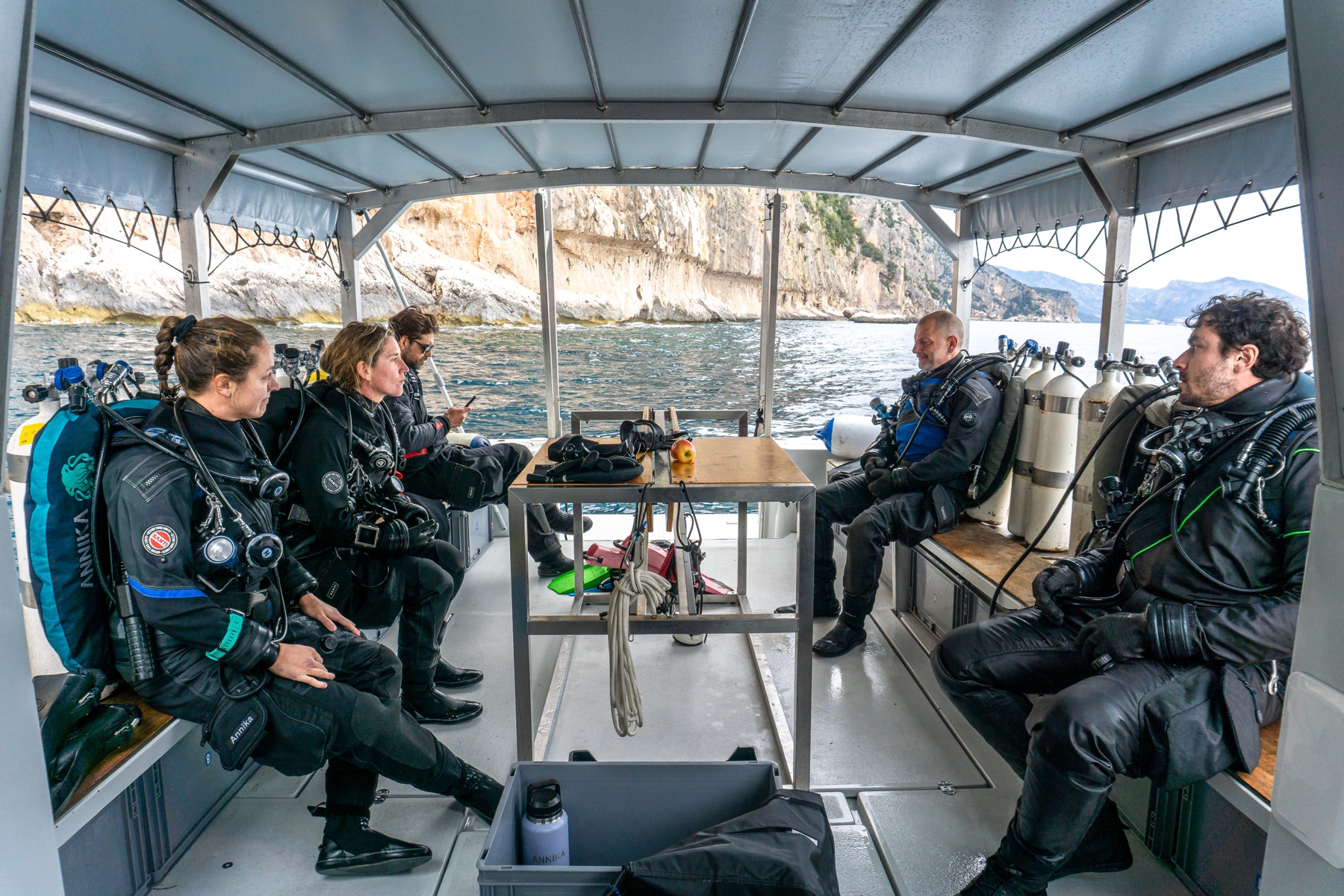Dive team pre-dive briefing on the boat