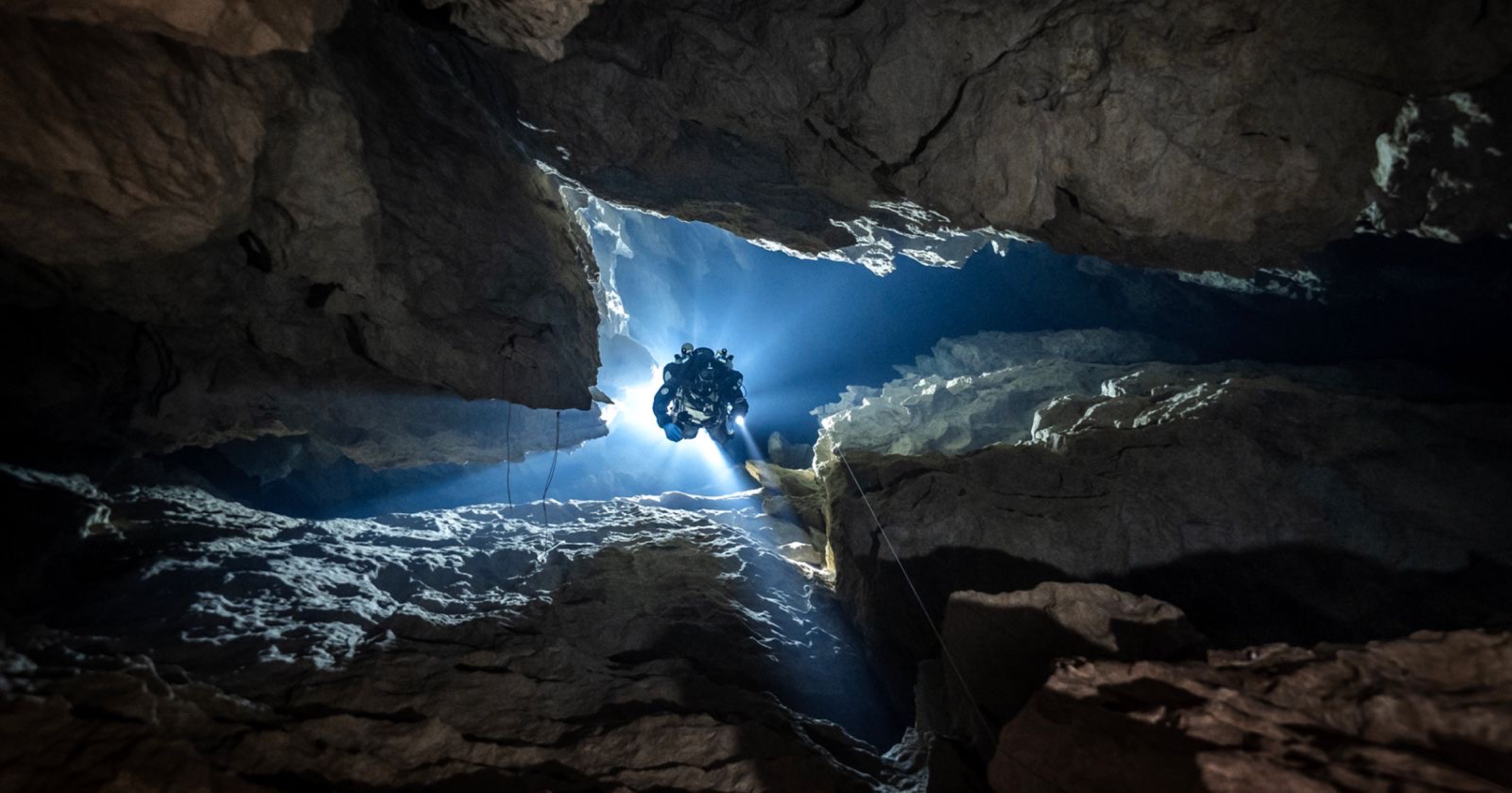 Solo diver with light shaft from above