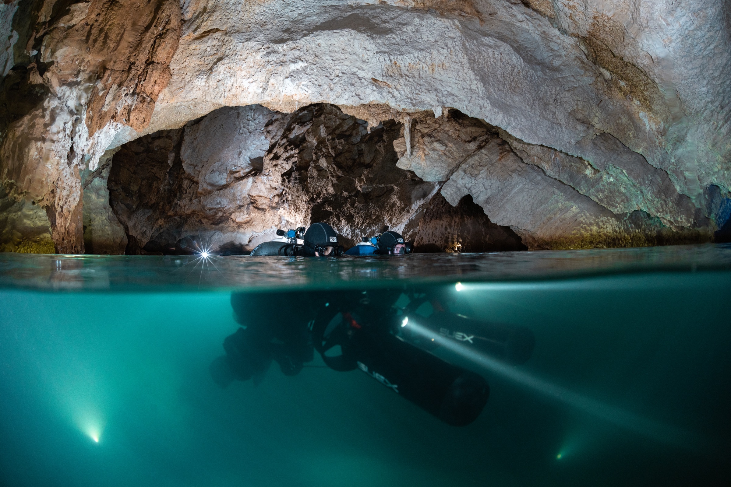 Cave entrance, divers at the surface